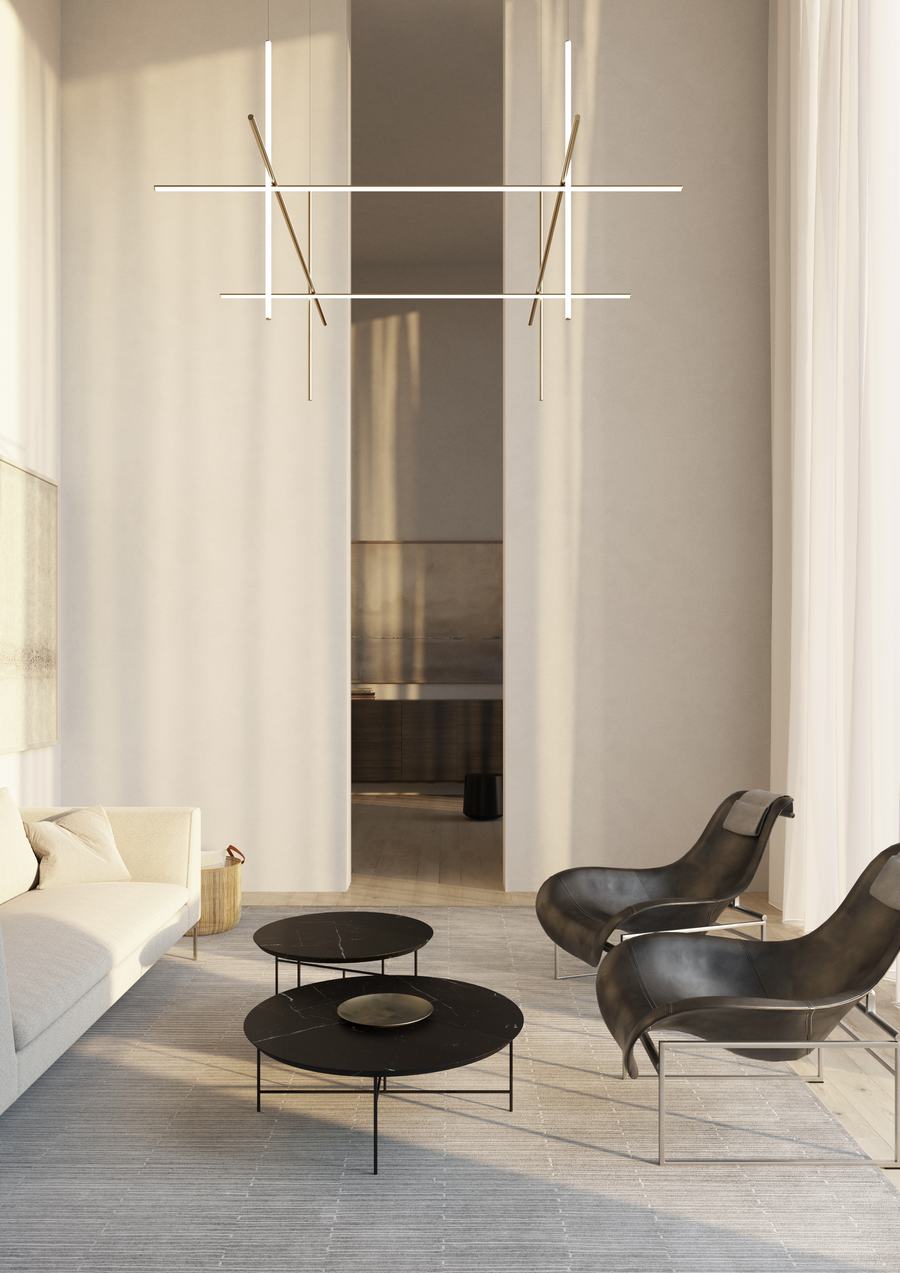 Salotto alto con poltrone in pelle nera, tavolini scuri e lampade lineari